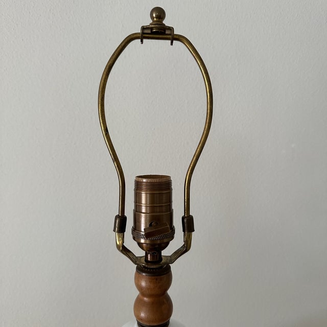 Vintage table lamp with carved wood base and white milkglass with hobnail detail. A new socket with paddle style turn knob...