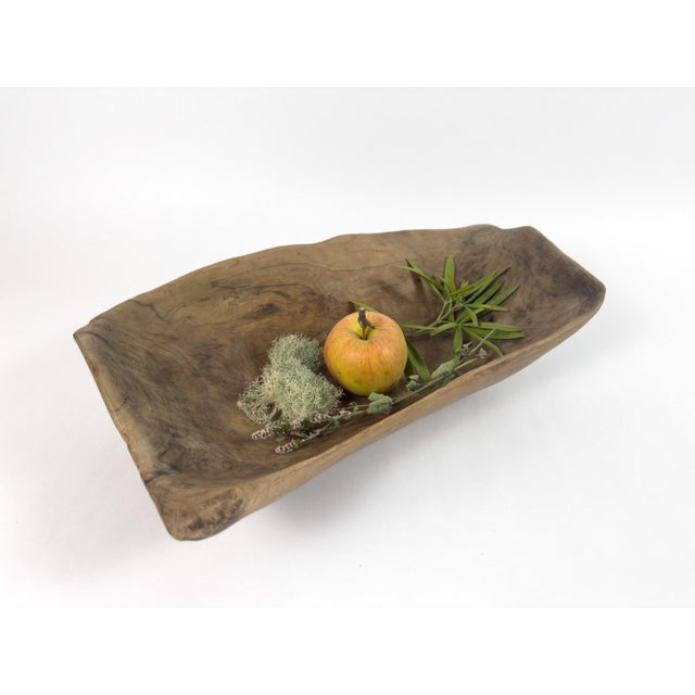A beautifully sculptural vintage wooden trough bowl, hand-carved from a single solid piece of wood and distinguished by...