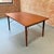 This teak Danish Modern dining table is in immaculate condition for it's age. The patina on the solid brass supports is...
