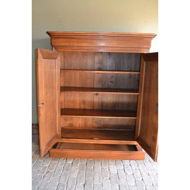 19th-century French Louis Philippe cabinet. The height is 183 cm. The width is 146 cm. The depth is 55 cm. Shelves behind...