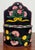 Charming farmhouse style tole hand painted metal wall pocket. Black background with pink and yellow flowers on green...