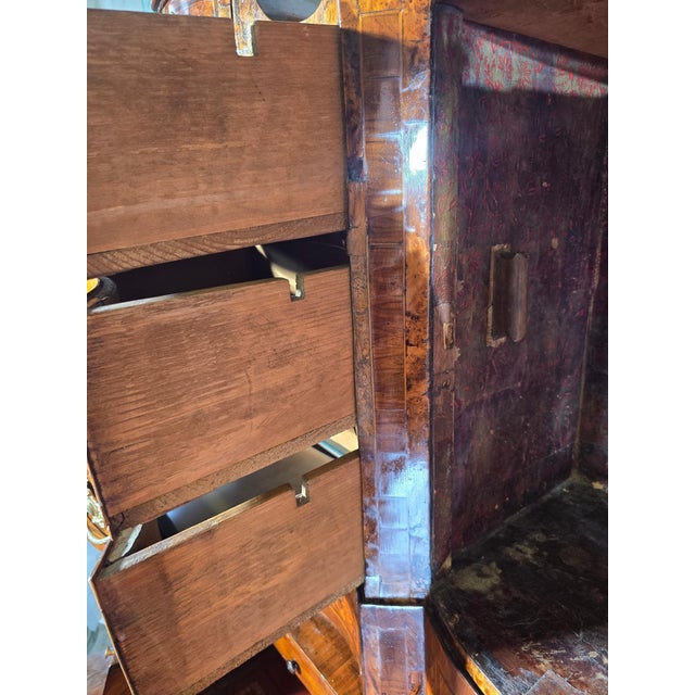 An elegant German cabinet from the early 18th century, circa 1720, crafted from a combination of fine woods including...