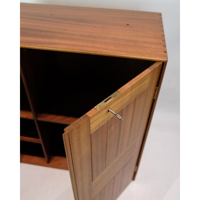 Classic mahogany cabinet, designed by mogens koch and produced by rud. Rasmussen in the 1970s. The cabinet has two doors...