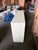 A striking sculptural console featuring a clean, architectural form finished in warm ivory lacquer, contrasted by an...