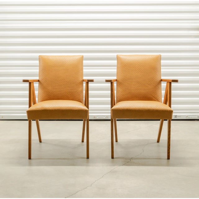 Pair of scissor frame modernist armchairs newly upholstered in a saddle colored, basketweave textured leather, France...