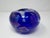 Hand-blown studio art glass vase in a rich cobalt blue hue, featuring shimmering iridescent metallic inclusions...