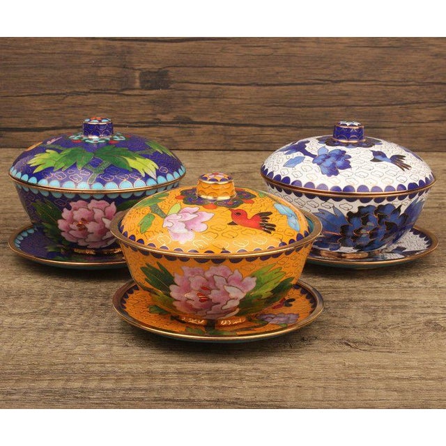 This is a striking set of four vintage cloisonné enamel lidded bowls , each complete with a matching saucer. This...
