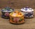 This is a striking set of four vintage cloisonné enamel lidded bowls , each complete with a matching saucer. This...