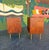 A sleek end table pair by famed designer, Jens Risom. Both retain tags inside the doors. Walnut cases with brass handles...
