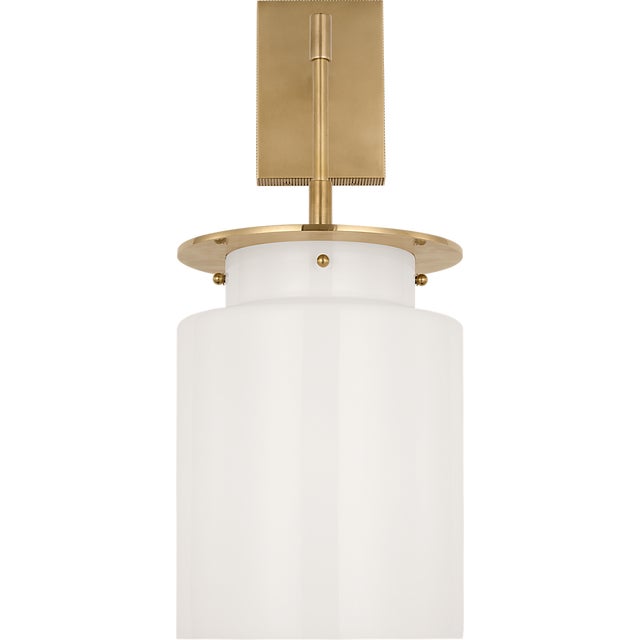Elias 23" Sconce in Antique-Burnished Brass with White Glass Designer: Ray Booth Finish: Antique-Burnished Brass Height:...