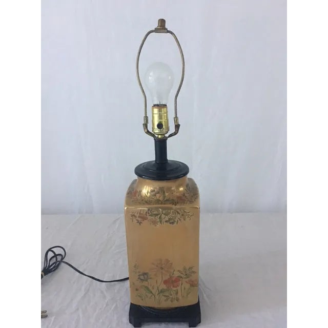 Exquisite hand painted burnished gold floral lamp on a black Asian inspired base. Measures 25" tall to top of socket, 19...
