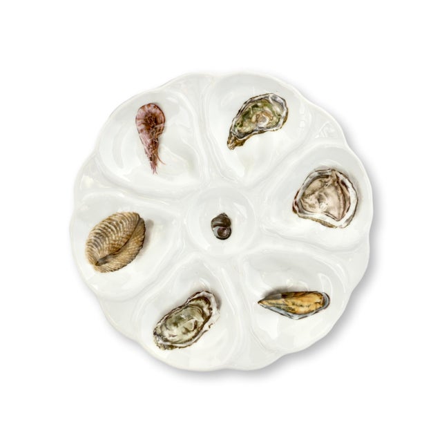 Early 20th century French porcelain oyster service comprising one large serving platter and six individual oyster plates....
