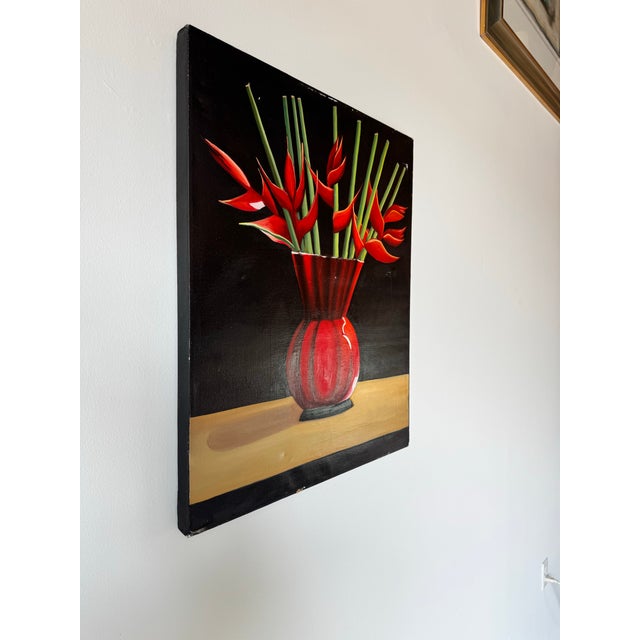 This striking vintage oil painting captures the vibrant beauty of tropical flora, featuring a bold red vase filled with...