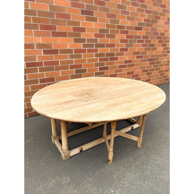 Late 19th century English gateleg table handcrafted from solid oak. Featuring drop leaves, turned legs, and a beautifully...