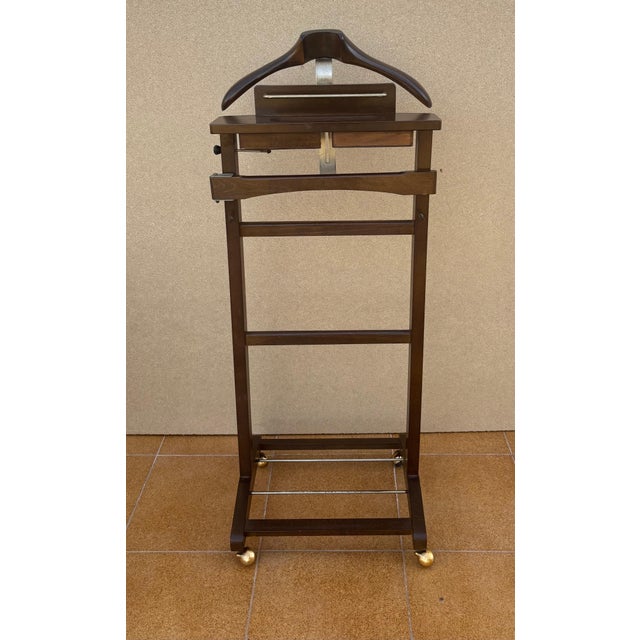 Elegant vintage valet stand, crafted in wood with a clean and practical design. This functional piece features an...