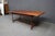 Antique walnut harvest table featuring a two-board top with a rich, warm brown finish and a simple molded edge. The...