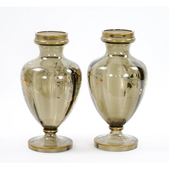 Experience the allure of the past with this captivating pair of antique French hand-gilt and decorated enameled gray-...