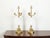 A pair of French Empire style bronze and opaline glass candelabra table lamps from the early 20th century, with scrolling...