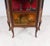 A decorative French kingwood vitrine cabinet dating to around 1900, richly mounted with ormolu mounts and topped with a...