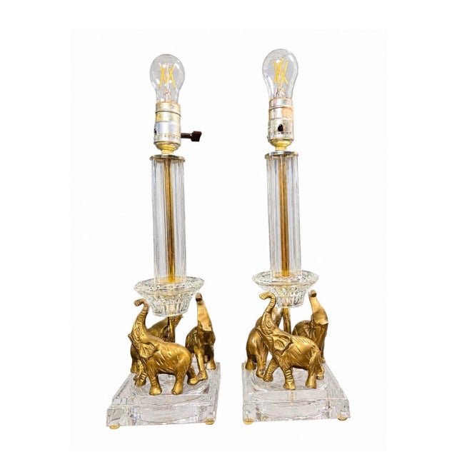 Bring timeless Hollywood Regency elegance to your home with this beautiful matching pair of vintage brass elephant table...