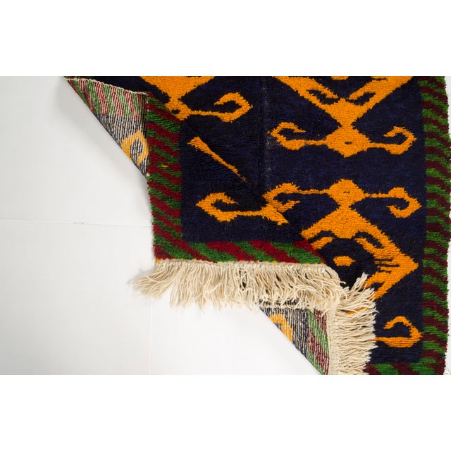This is a vintage Turkish Oushak rug from the Mid 20th Century. The piece was hand-knotted.