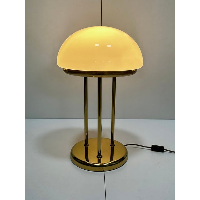 Elegant, large German table or floor lamp from the 1970s with a heavy brass body and a large opal glass dome. The dome...