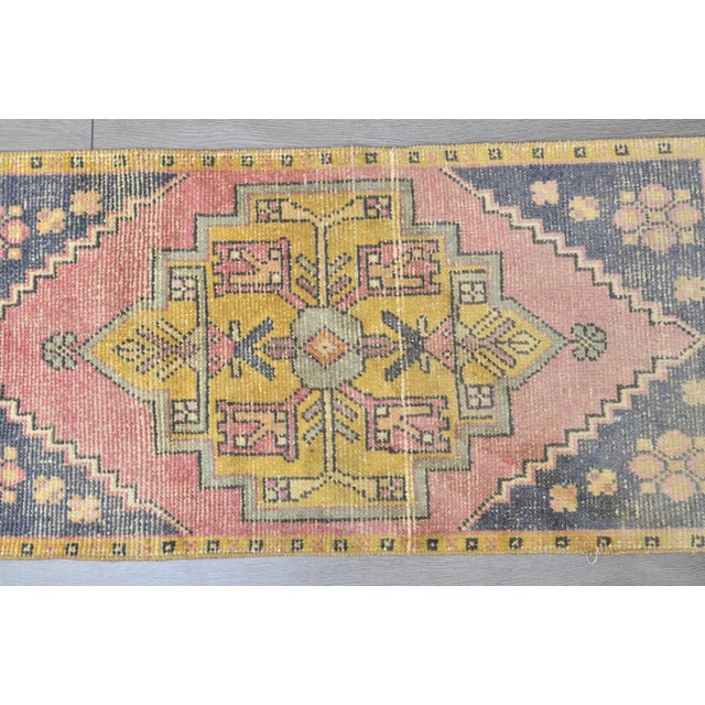 This is a vintage Turkish Oushak rug from the 1960s. The piece was hand-knotted.