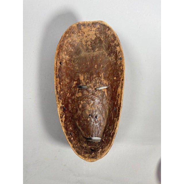 LEGA, Democratic Republic of Congo. Ceremonial wooden mask with a dark patina covered in kaolin. H. 32 cm - W. 16 cm - D....