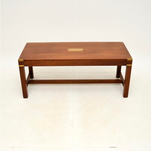 A superb antique military campaign style coffee table. This was made in England, it dates from around the 1930’s. The...