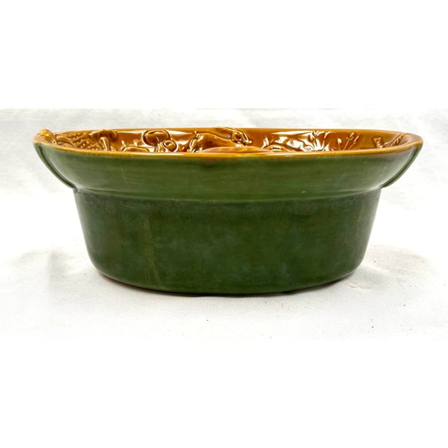 Wild game adorn the edge of this lovely French casserole -- rabbit, deer, boar, and pheasant. The exterior is glazed in...