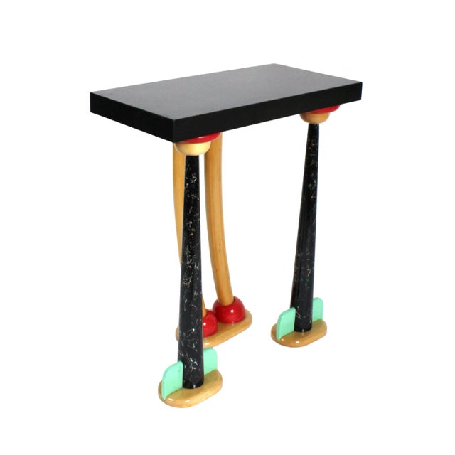 Bold and bright console or hall table. Features uniquely shaped solid maple legs with splatter lacquered tapered legs on...