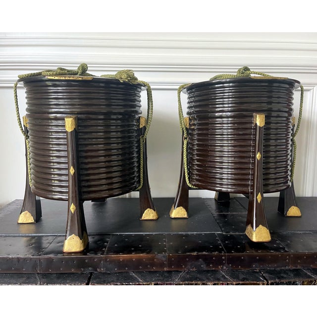 A pair of Japanese lacquer lidded Hokai boxes with chased brass hardware and original ropes. Hokai boxes are traditionally...