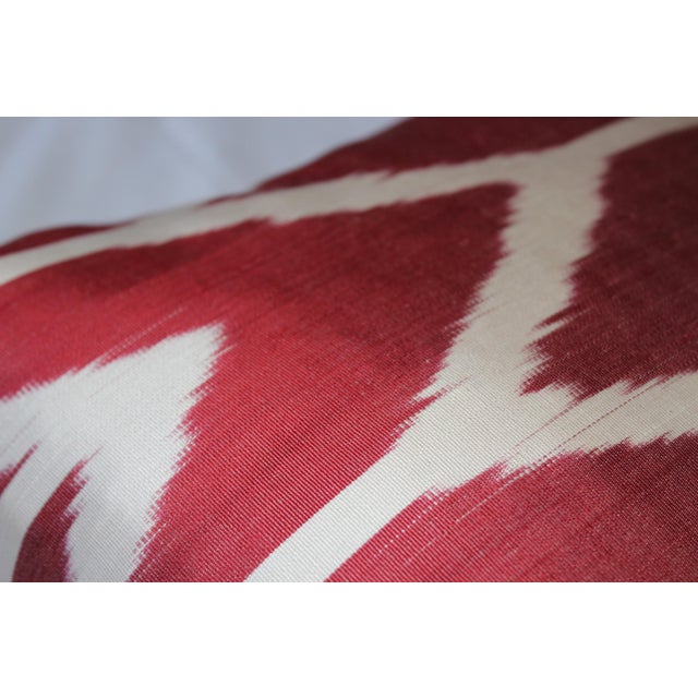 Bohemian silk ikat pillow with vibrant colors of red, beige . Super hand soft. Pillow has a zipper for closure. Insert is...