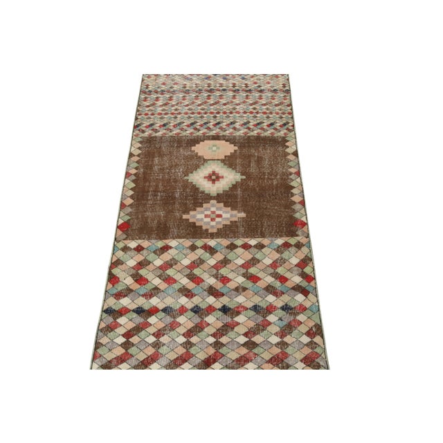 Hand-knotted in wool from Turkey originating between 1960-1970, this vintage mid-century modern rug is the latest to join...