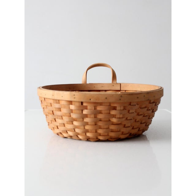 A vintage handwoven basket brings warmth, natural texture, and timeless charm to any space. Featuring a classic round...