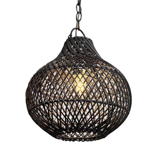 Black finish hand woven wicker Bawang style hanging lantern. Beautiful warm glow when illuminated. Each may vary in...