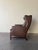 Elegant mid-century Danish wingback lounge chair, crafted in the 1960s and executed in richly patinated brown leather,...