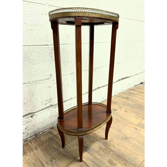 This is a gorgeous antique Louis XVI style Bouillotte side table or occasional table. It features a gorgeous oval shape...