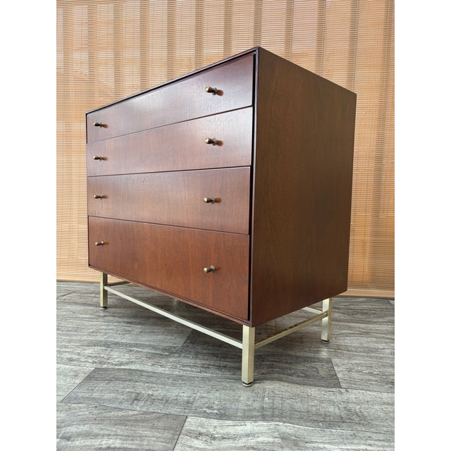 Vintage Refinished Mid Century Modern Chest of Drawers By John Stuart. Circa 1960s. Features a quintessential Sleek Mid...