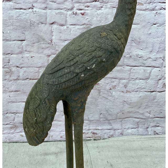 Pair of 20th Century Cast Iron Crane Sculptures. Cranes are crafted with meticulous attention to detail, capturing the...