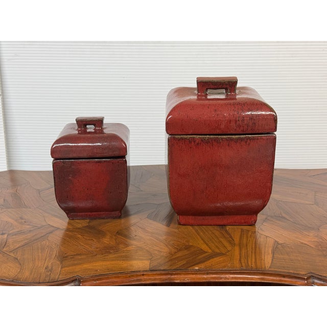 Design Plus Gallery presents a Set of Two Glazed Ceramic Lidded Canisters. Offered in two different sizes, each canister...