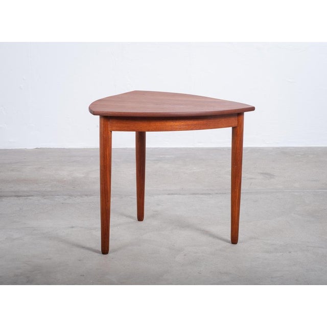 A triangular coffee or side table in teak, produced in the 1960s. The versatile form allows it to function equally well as...