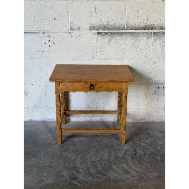 This side table features turned legs, an apron, and a single pull-out drawer. The overall silhouette offers a timeless...