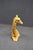 Decorative seated giraffe sculpture featuring a hand-painted finish with textured patterning and expressive facial...