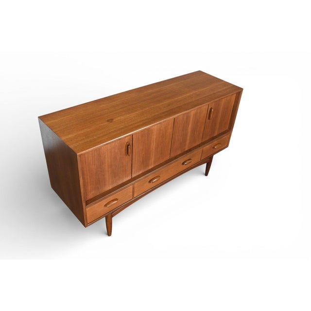 Origin: England Designer: Victor B. Wilkins Manufacturer: G Plan Era: 1964 Materials: Teak, Afromosia Measurements: 57″...