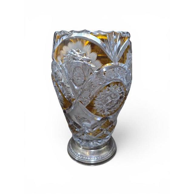 An elegant Bohemian cut crystal vase, distinguished by its richly worked bicolor crystal body and refined silver base, an...