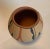 3 1/2" x 3 1/8" Southwestern Pottery Vase, signed M.M. in rich tones of black, copper, and tan in a beautiful repeating...