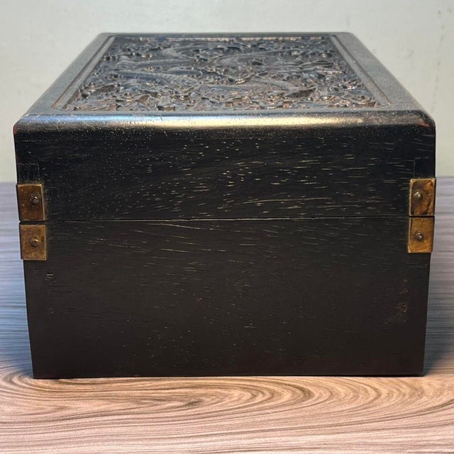 A striking vintage Chinese hardwood jewelry or keepsake box, crafted from dark, heavily grained Blood Sandalwood. The lid...