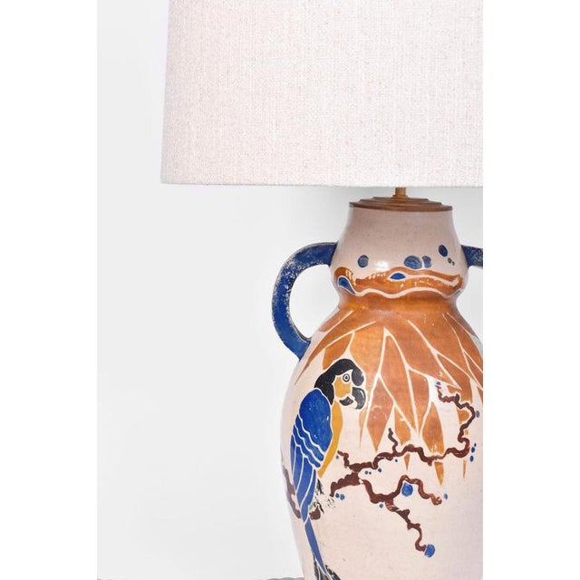 Parrots ceramic lamp, 1930s. Art Deco important ceramic lamp ornamented with two handles and decorated with a parrot and...