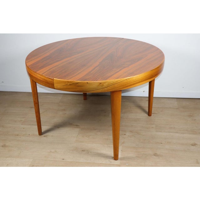 Beautiful Scandinavian teak dining table from the 1960s, featuring an elegant circular top with a built-in central...